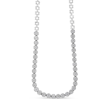 Front-facing view of a white metal necklace with round white gemstones in a pave setting along the lower half.
