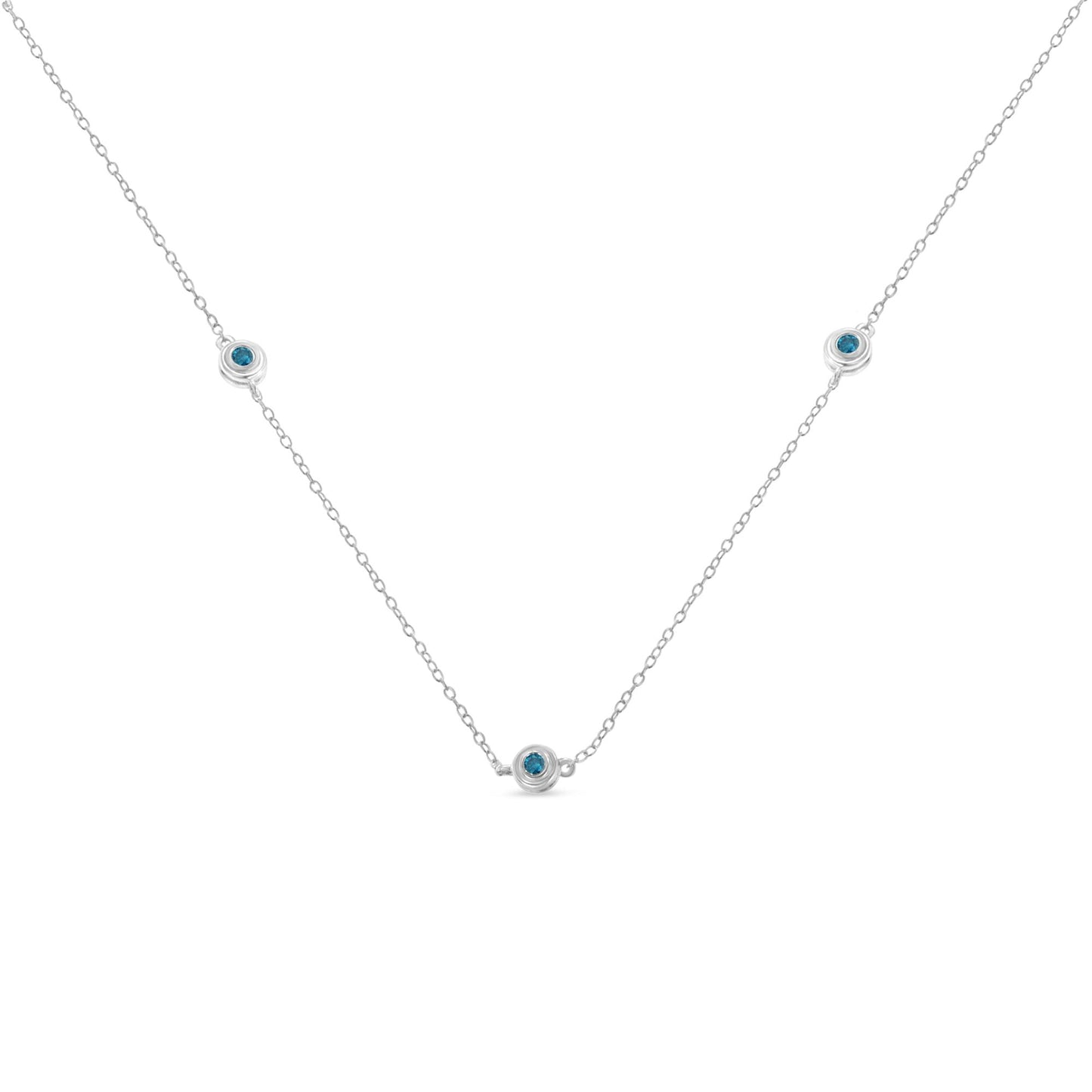 Front-facing view of a white necklace with a delicate chain featuring three round blue gemstones set in bezel settings evenly spaced along the chain.