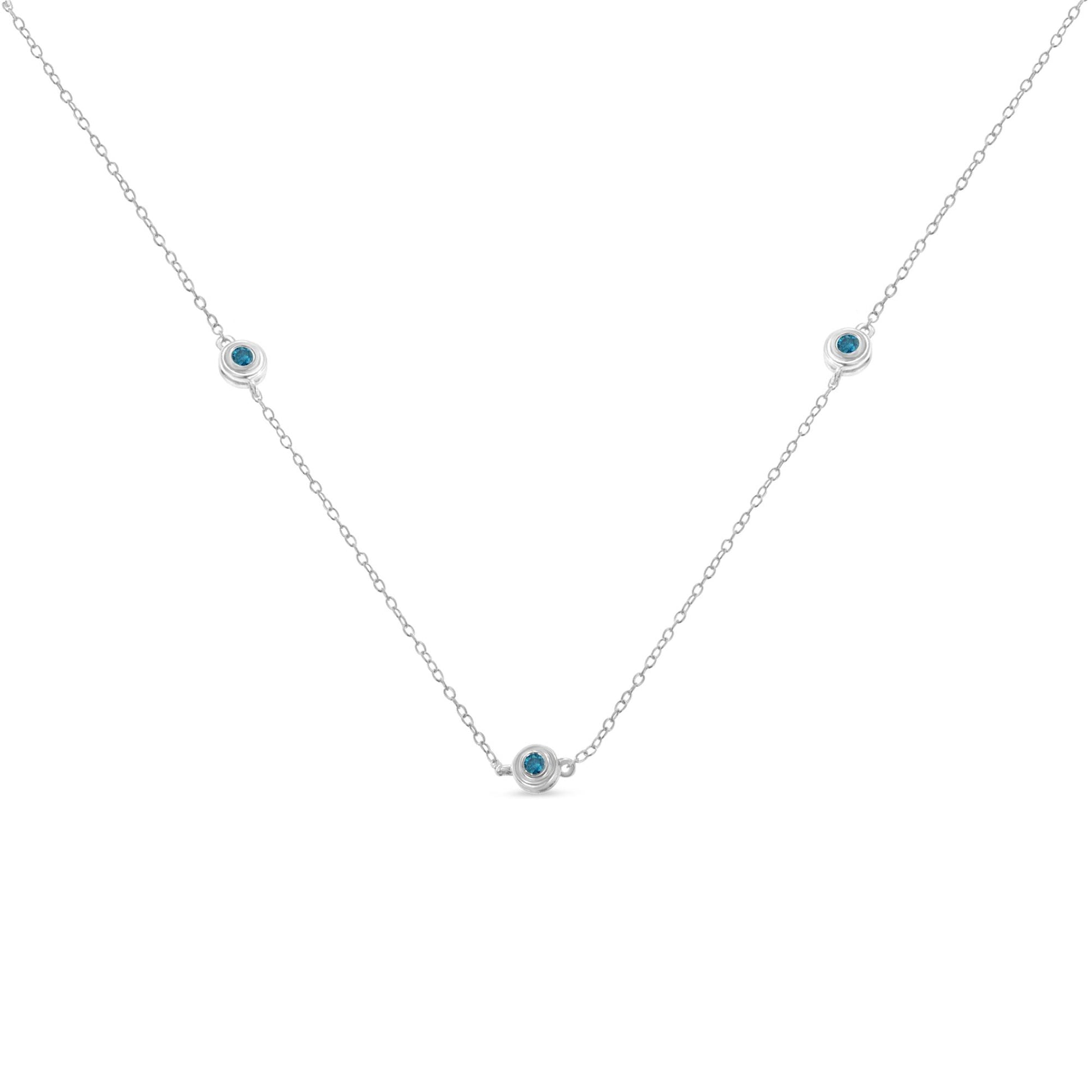 Front-facing view of a white necklace with a delicate chain featuring three round blue gemstones set in bezel settings evenly spaced along the chain.