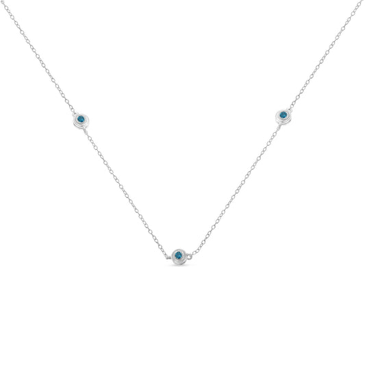 Front-facing view of a white necklace with a delicate chain featuring three round blue gemstones set in bezel settings evenly spaced along the chain.