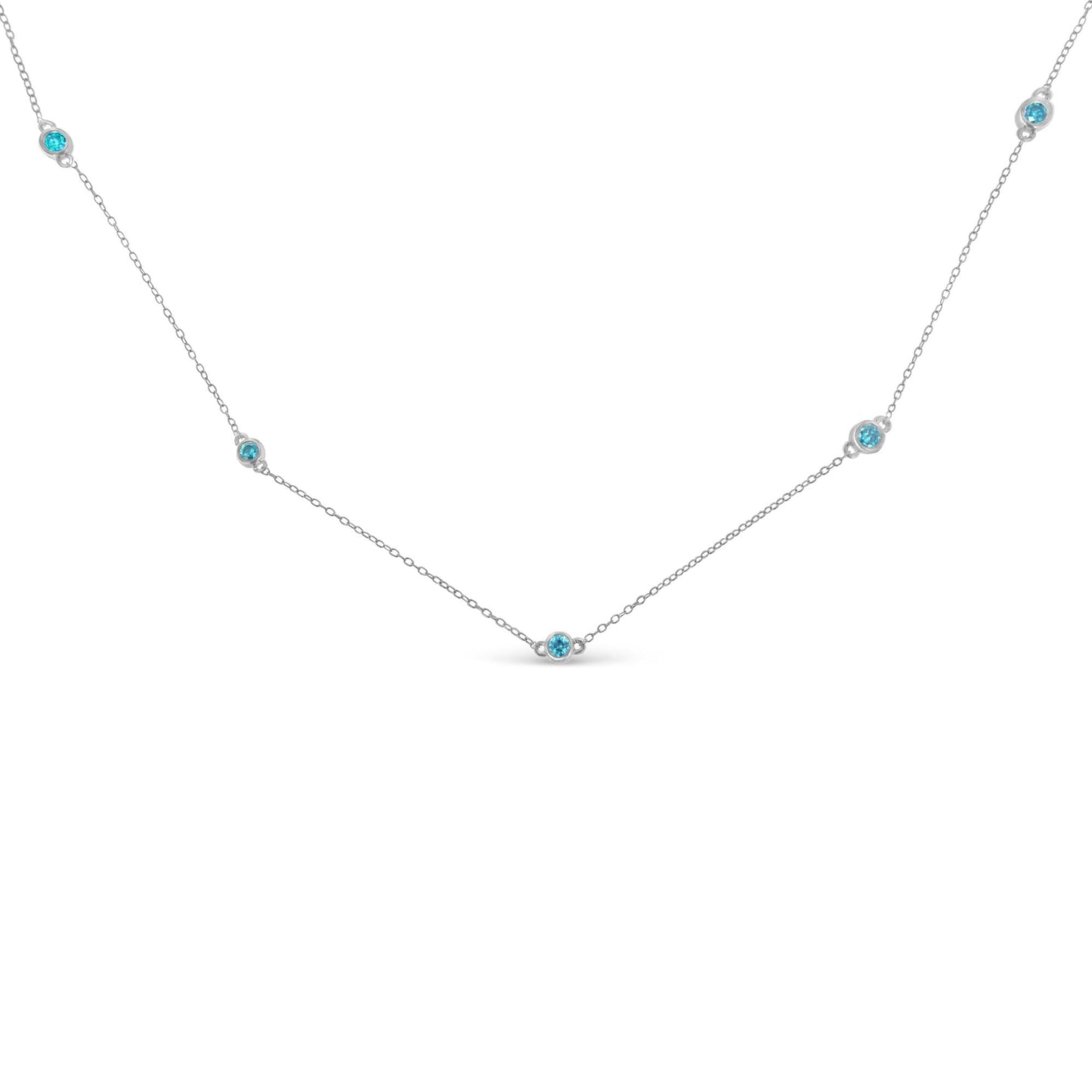 Close-up front angle of a white metal necklace featuring five round blue gemstones in bezel settings evenly spaced along a delicate chain.