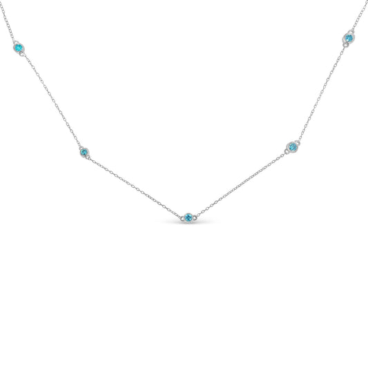 Close-up front angle of a white metal necklace featuring five round blue gemstones in bezel settings evenly spaced along a delicate chain.