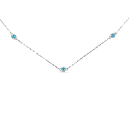 Front view of a white metal necklace with five round blue gemstones in bezel settings evenly spaced along the chain.