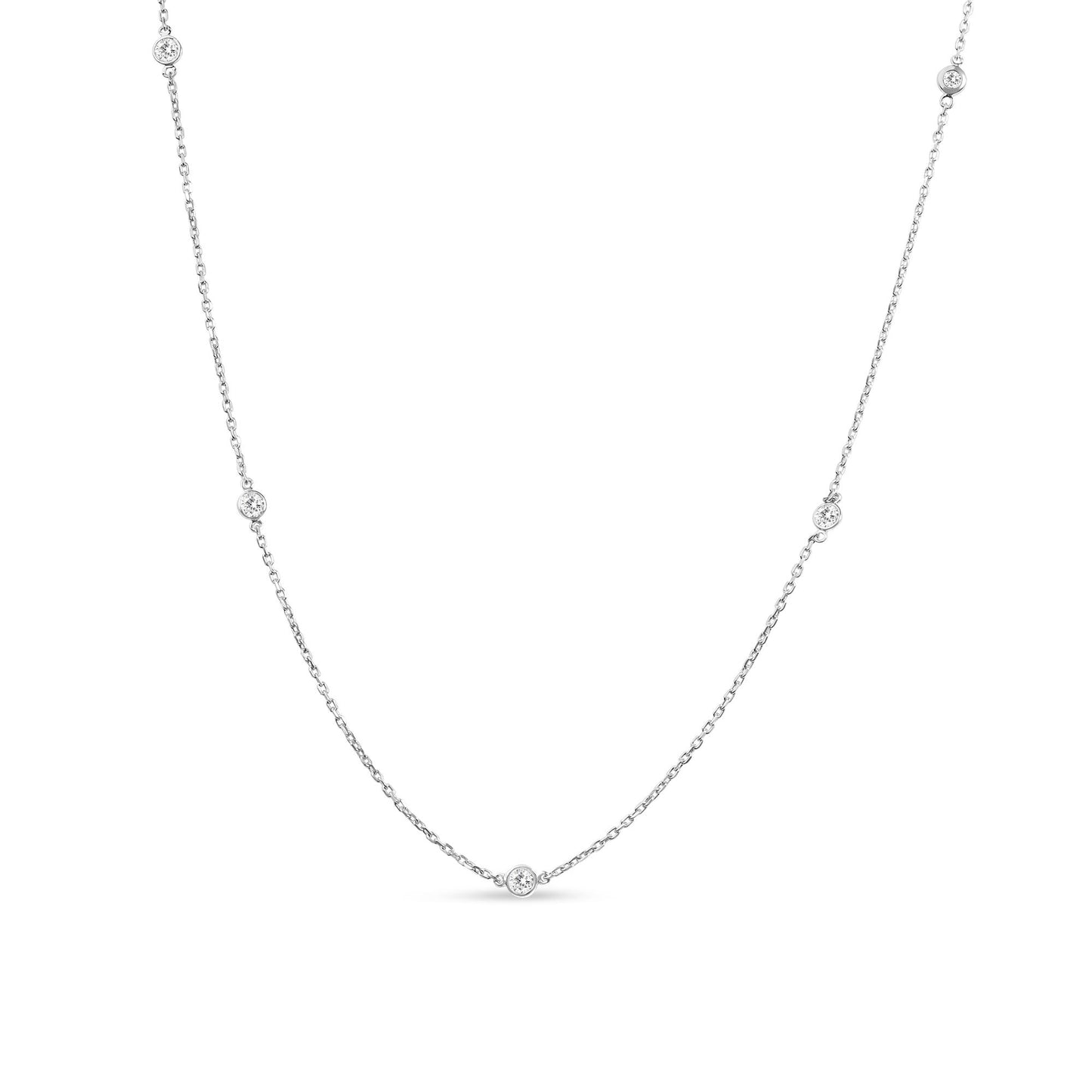 Front-facing close-up of a white metal necklace with round white gemstones in bezel settings evenly spaced along the chain.