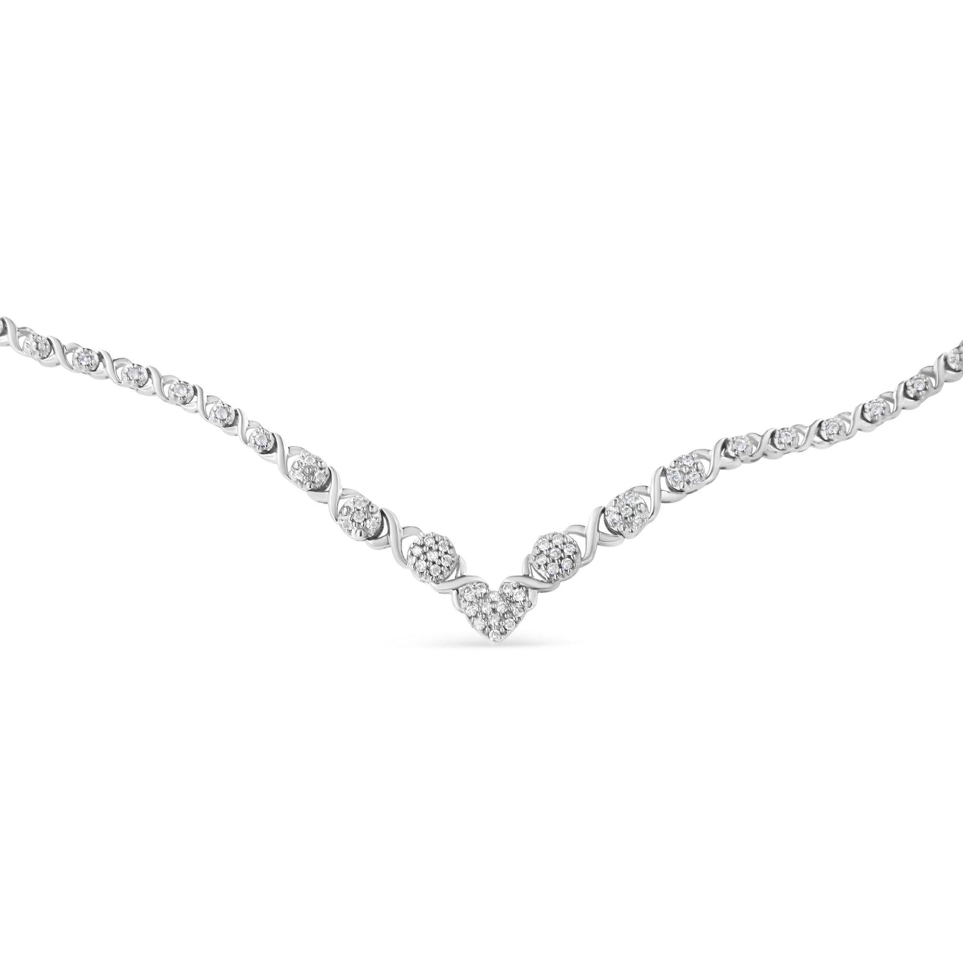 Close-up front angle of a white necklace with round-shaped white gemstones in a pave setting arranged in a V pattern.