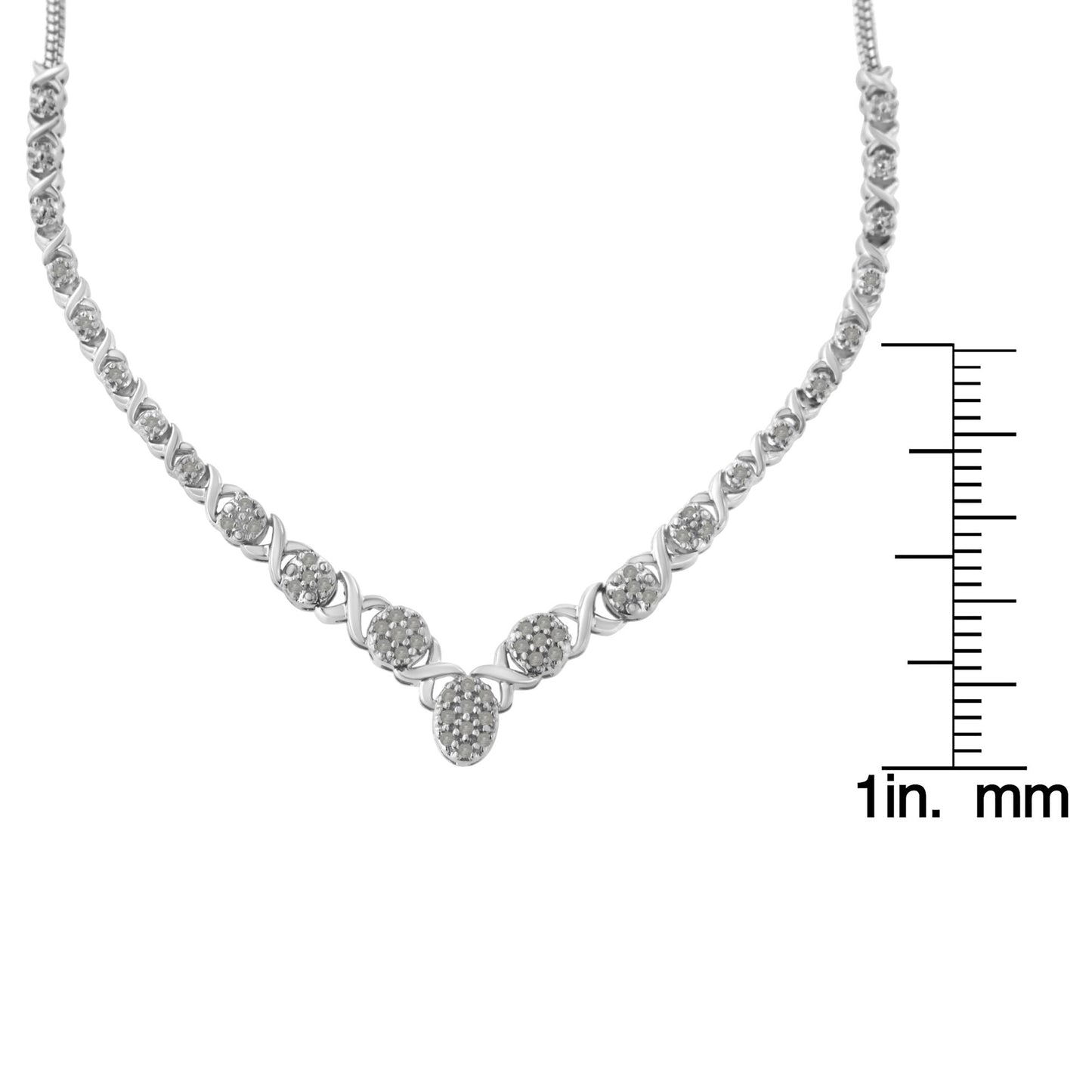 Close-up front view of a white metal necklace with round white gemstones in prong settings, displayed next to a ruler for size reference.