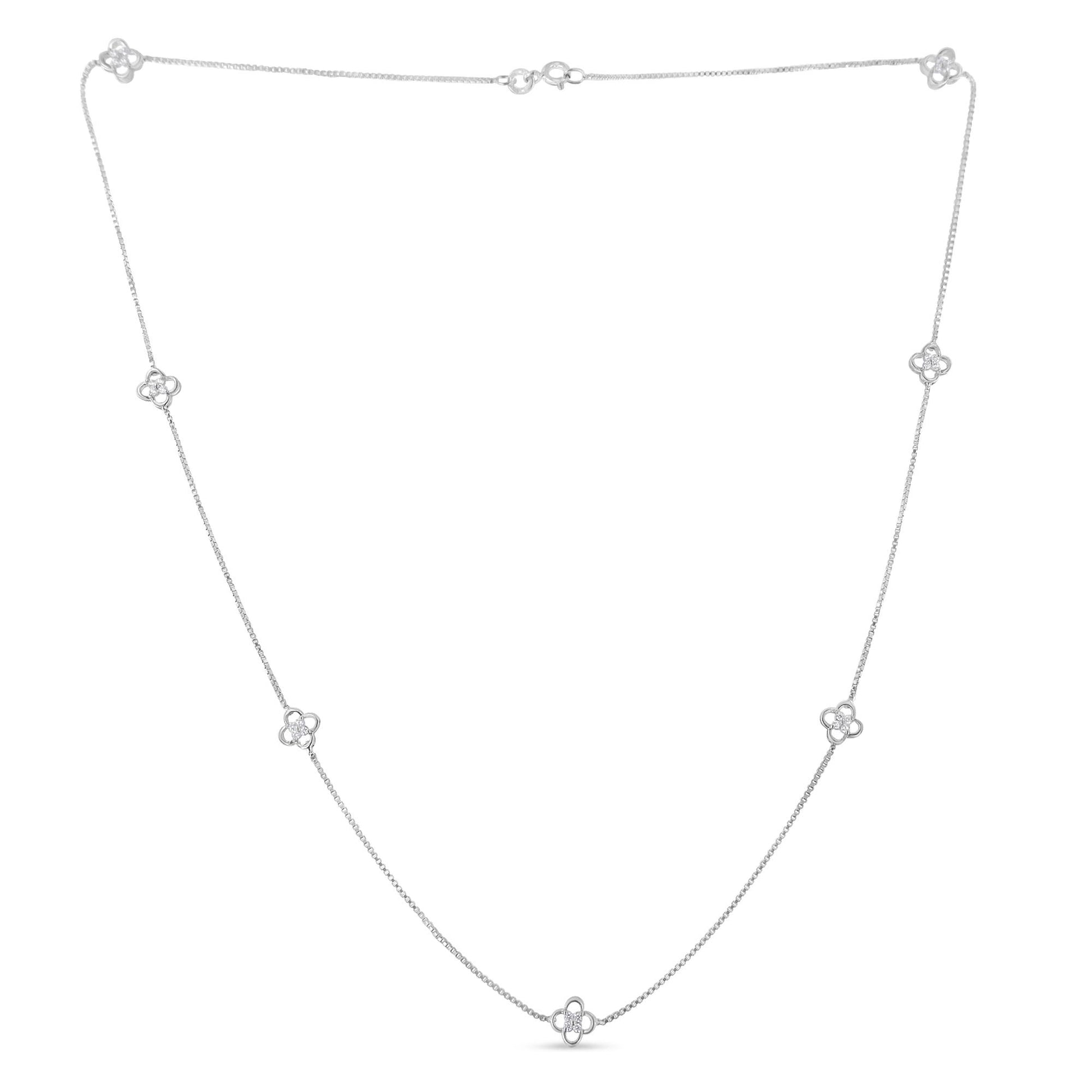 White metal necklace with small flower-shaped accents set with round white gemstones, shown flat from a front angle.