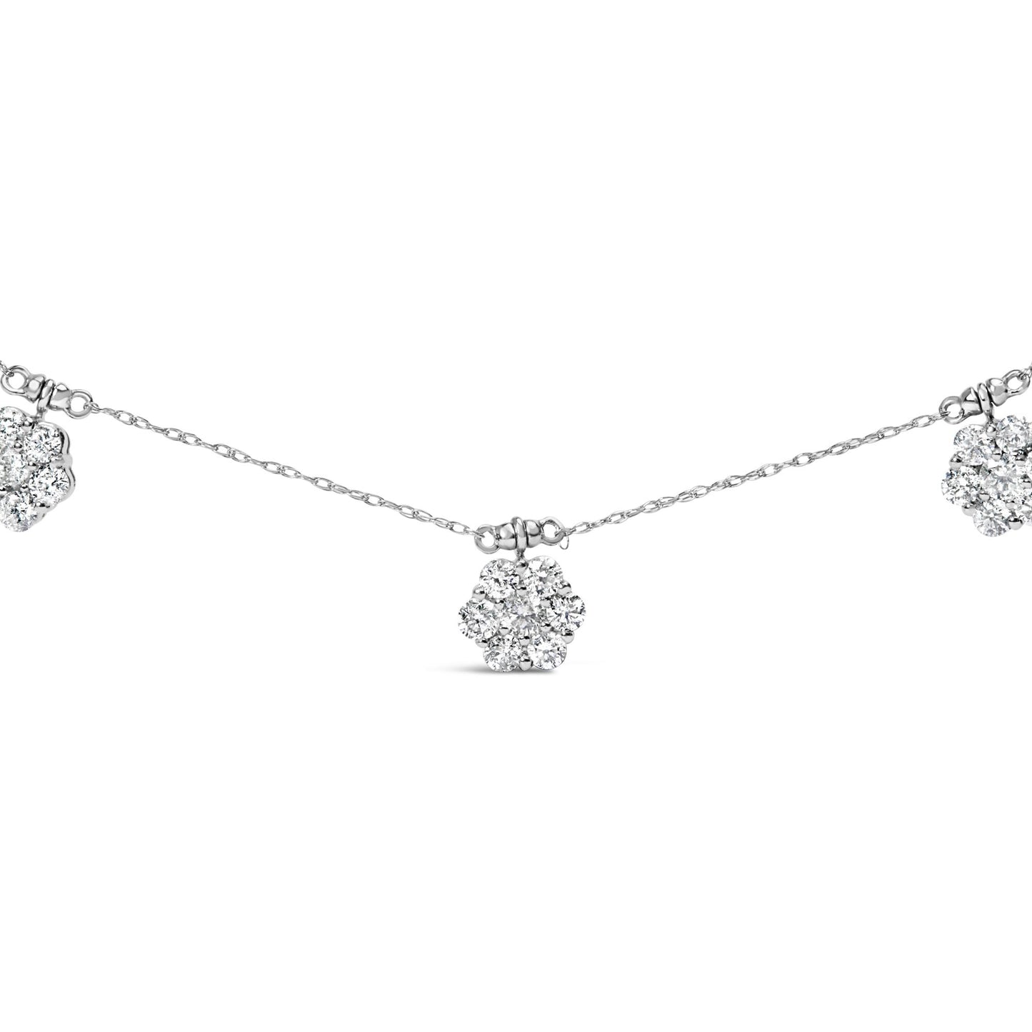 Close-up front view of a white metal necklace featuring multiple flower-shaped clusters of round white gemstones in prong settings spaced evenly along a delicate chain.