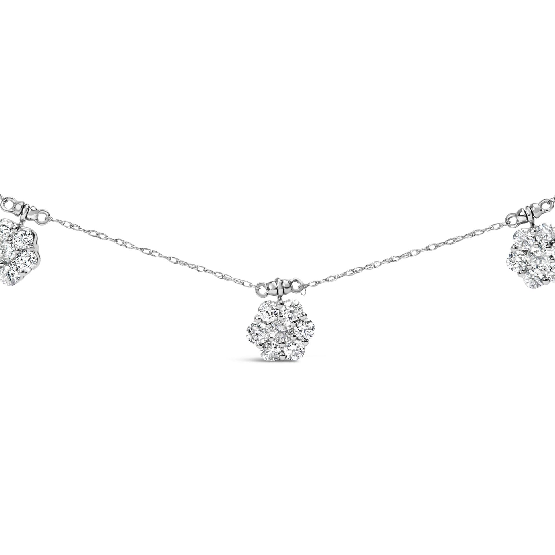 Close-up front view of a white metal necklace featuring multiple flower-shaped clusters of round white gemstones in prong settings spaced evenly along a delicate chain.