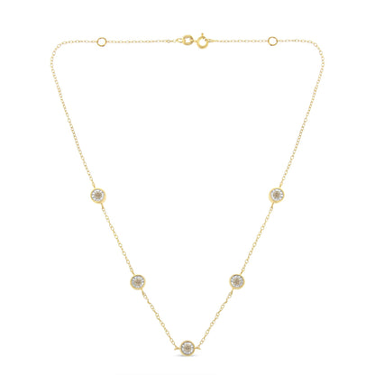 Front view of a yellow metal necklace with round brownish gemstones in miracle settings evenly spaced along a delicate chain.