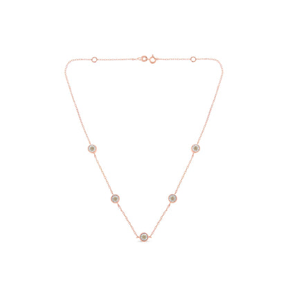Rose metal necklace with five round brownish gemstones in miracle settings, front-facing angle.