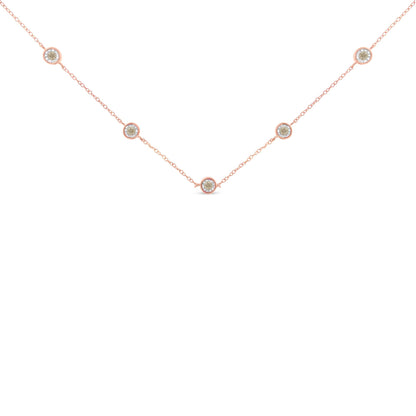 Close-up front view of a rose metal necklace featuring five round brownish gemstones in miracle settings evenly spaced along the chain.