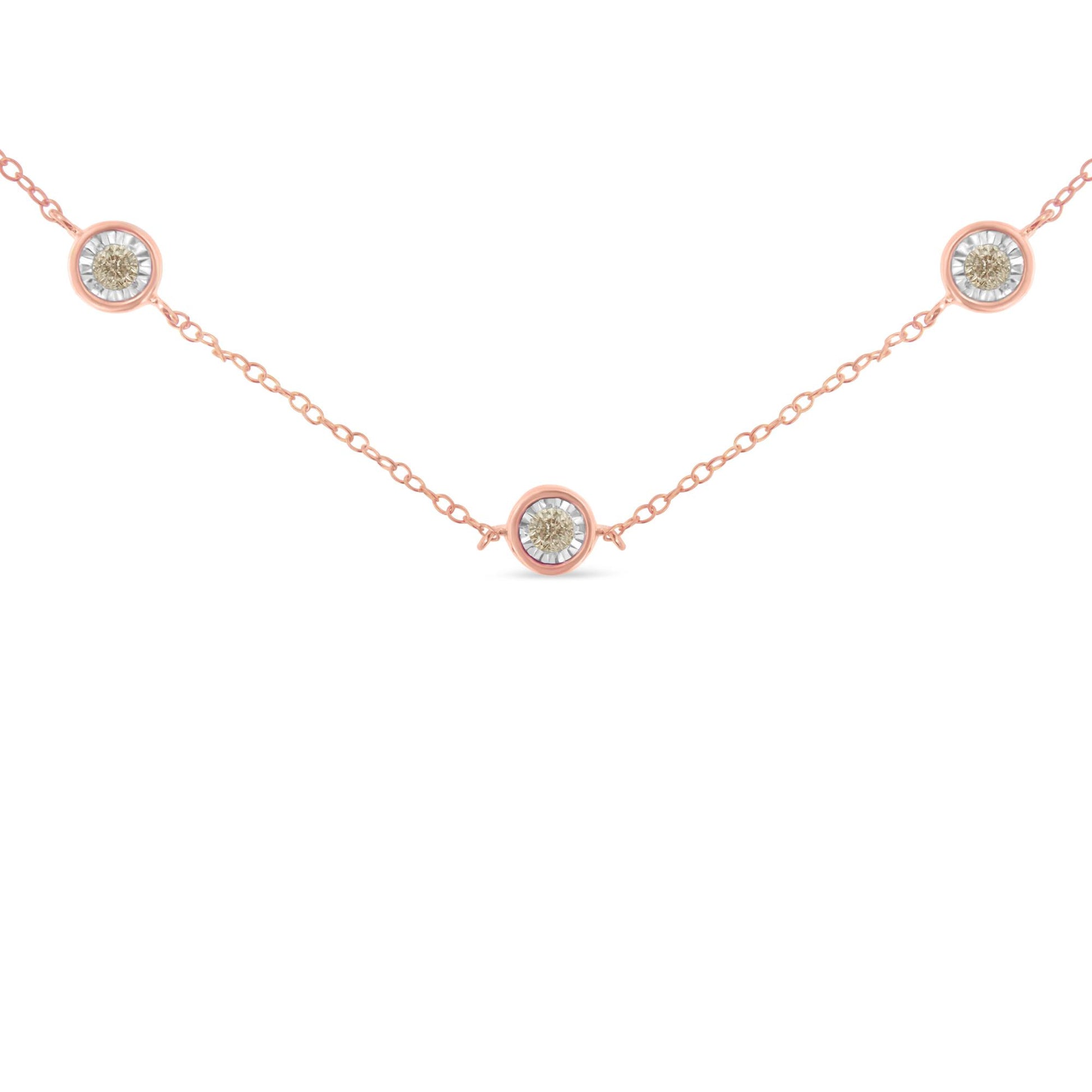 Rose metal necklace with three round brownish gemstones in miracle settings, shown from the front angle.