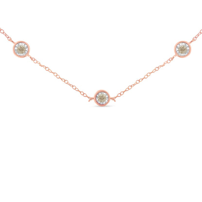 Rose metal necklace with three round brownish gemstones in miracle settings, shown from the front angle.