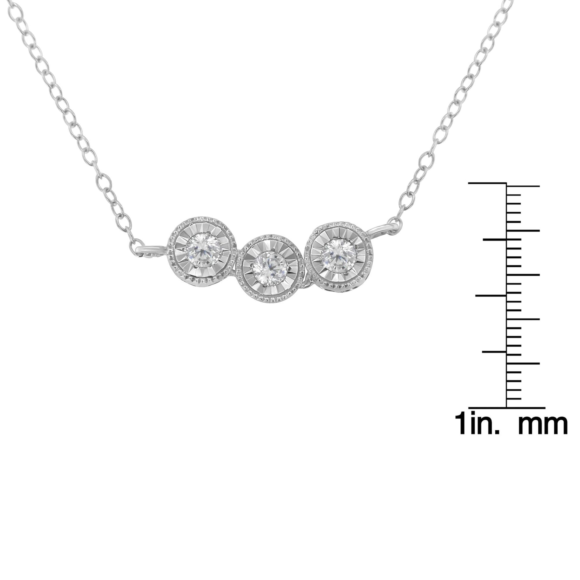 Close-up front-facing view of a white metal necklace with three round white gemstones in miracle settings, shown with a ruler for size reference.