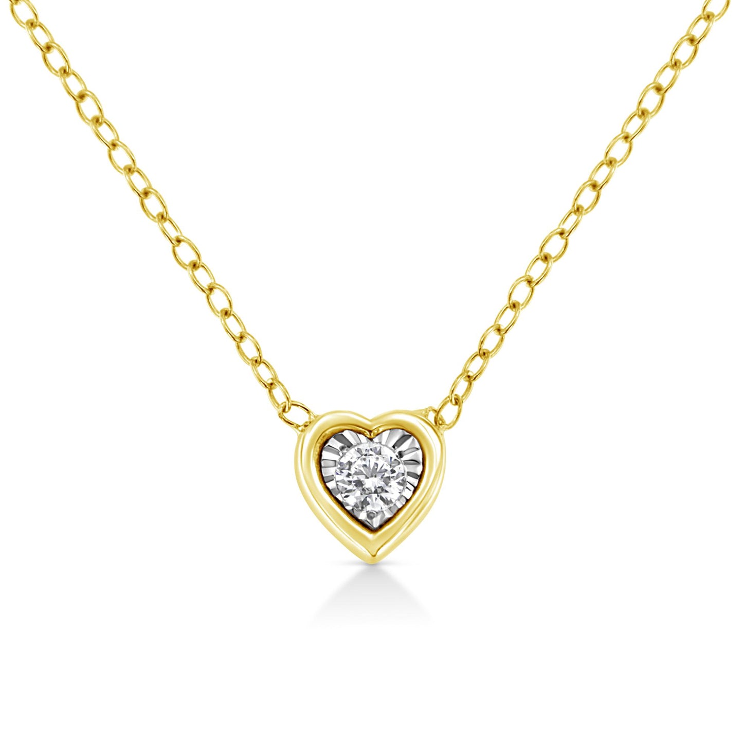 Front view of a yellow metal heart-shaped necklace pendant with a single round white gemstone in the center, set in a miracle setting.