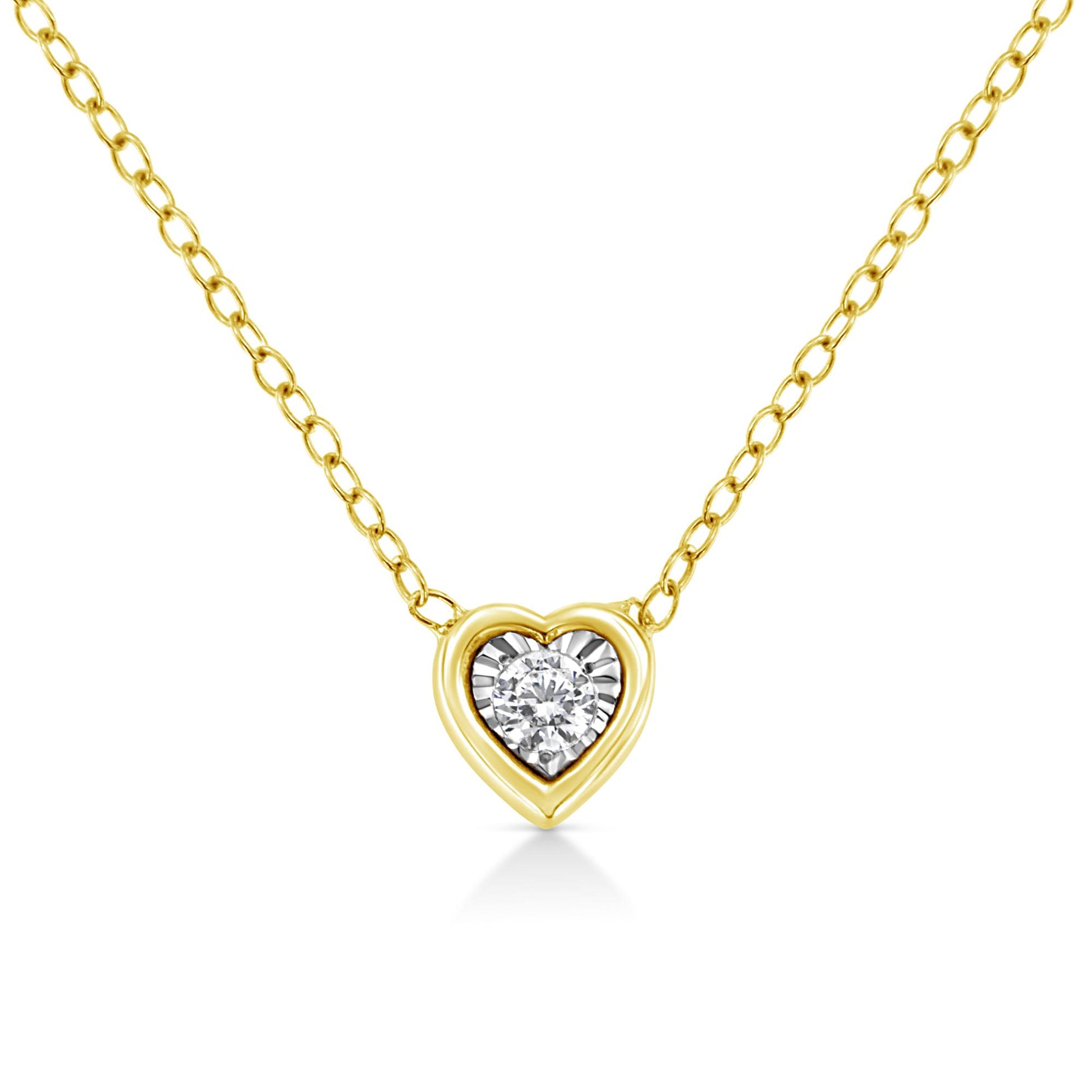 Front view of a yellow metal heart-shaped necklace pendant with a single round white gemstone in the center, set in a miracle setting.