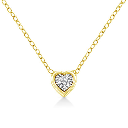 Front view of a yellow metal heart-shaped necklace pendant with a single round white gemstone in the center, set in a miracle setting.