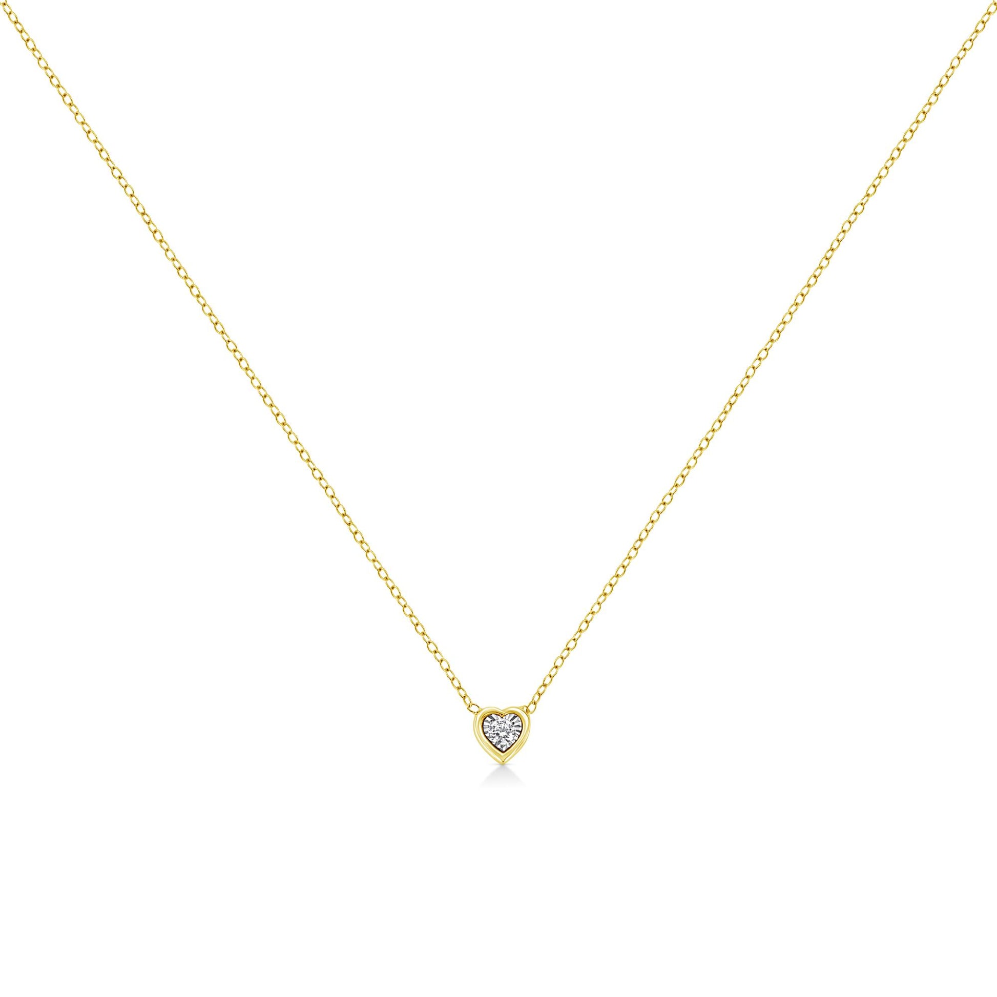 Front-facing shot of a yellow necklace with a heart-shaped pendant featuring a round white gemstone in miracle setting.