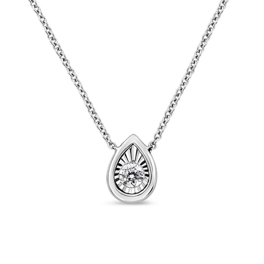 Front angled view of a white metal necklace with a teardrop-shaped pendant featuring a round white gemstone set in a miracle setting.