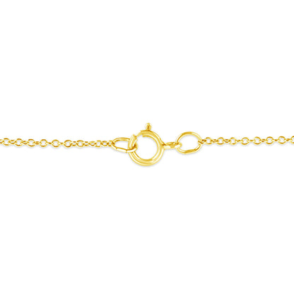 Close-up image of a yellow metal necklace clasp and chain links, shot from the front.