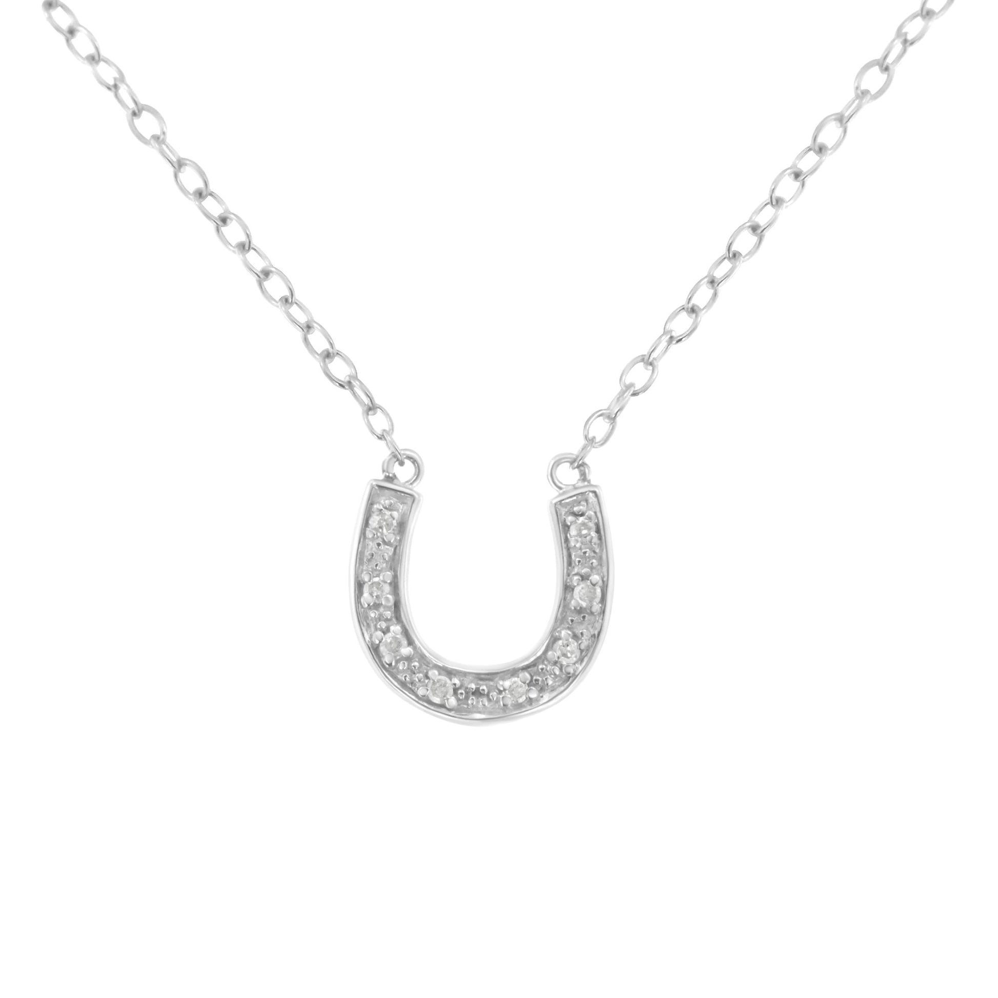 Front view of white metal horseshoe-shaped necklace pendant with round pave-set white gemstones on a chain.