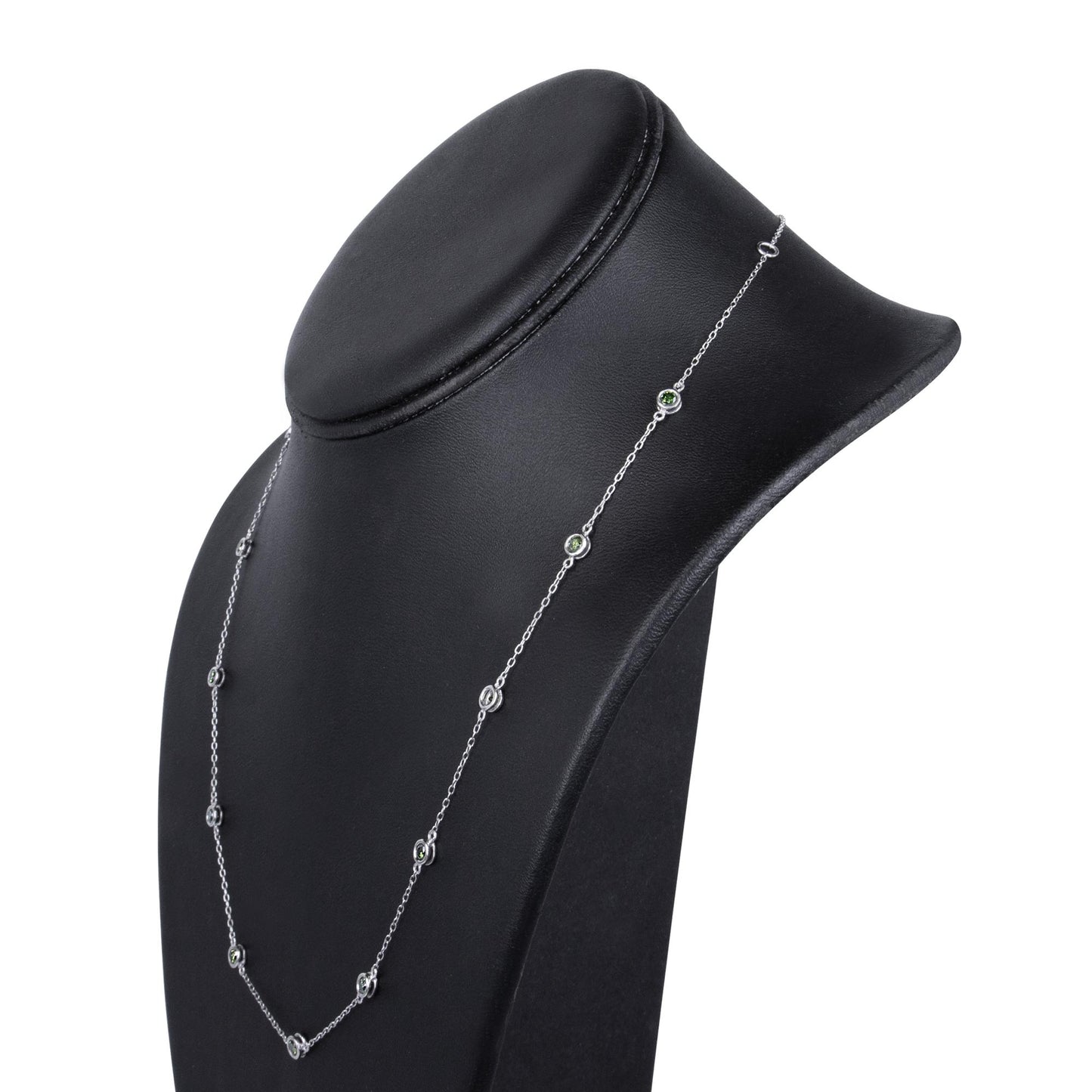 White metal necklace with round green gemstones in bezel settings, displayed on a black necklace stand, front angled view.