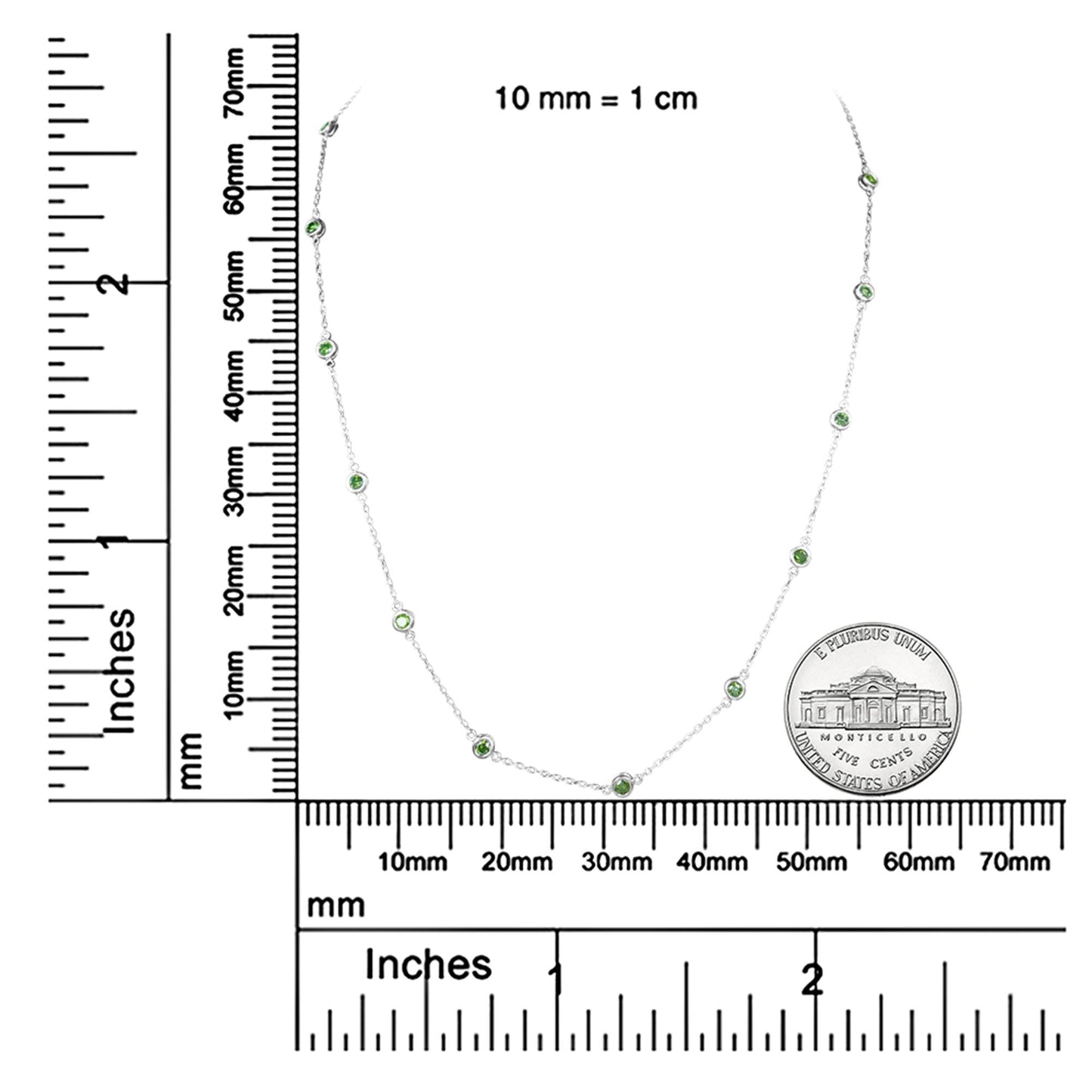 White necklace with round green gemstones in bezel settings, displayed flat on measurement rulers and next to a coin for size reference, shot from above.