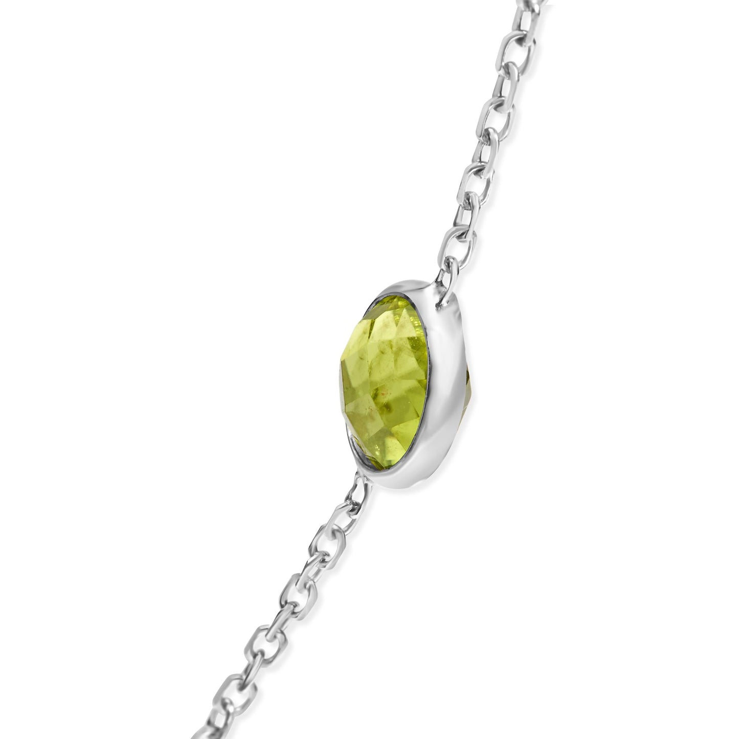 Close-up side angle of a white metal necklace chain featuring a single round yellow-green gemstone in a bezel setting.