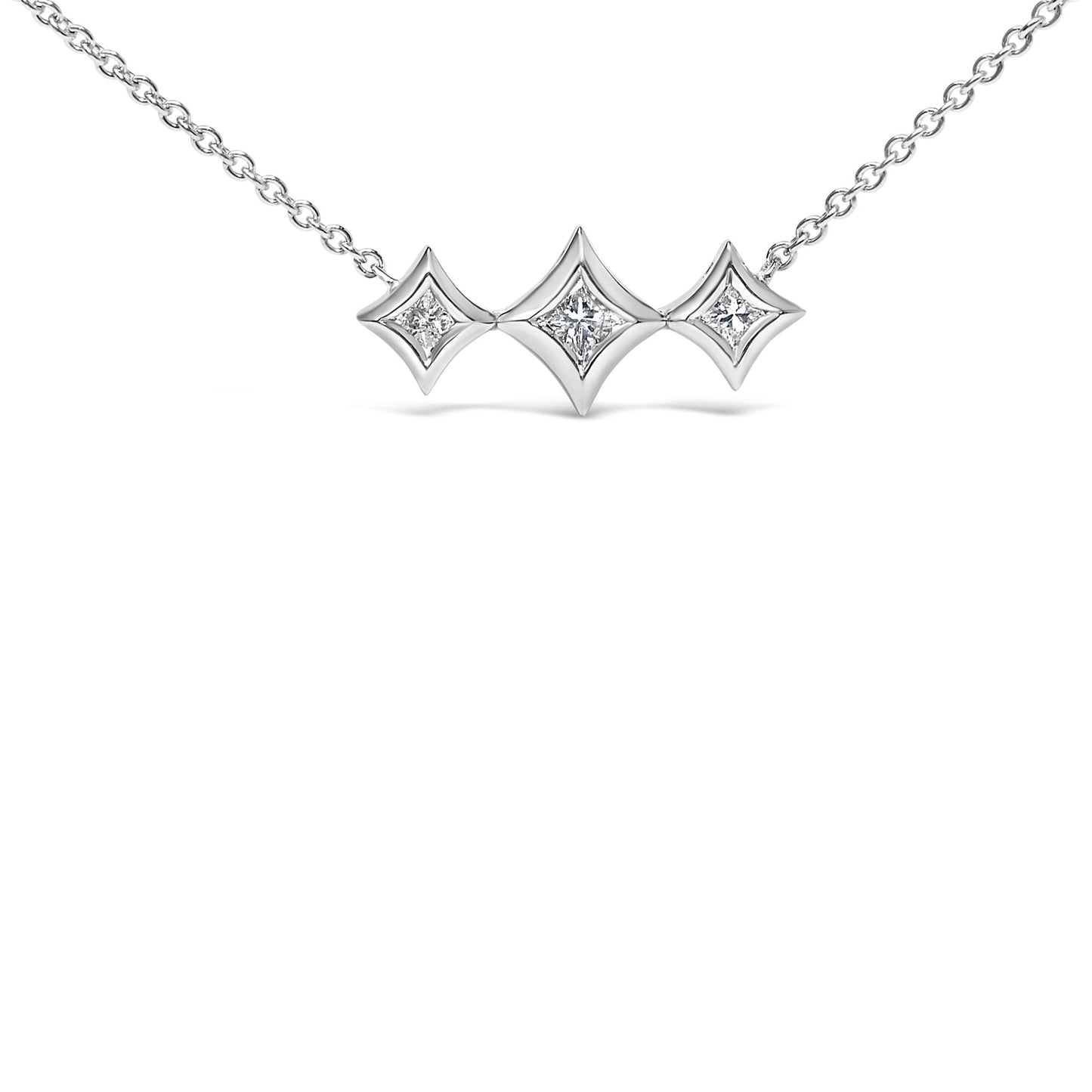 Front-facing shot of a white metal necklace with three connected square-shaped bezels, each set with white gemstones in round and princess shapes.