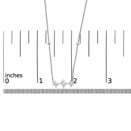 Close-up front view of white necklace with three bezel-set princess shape white gemstones in the center, accompanied by small round bezel-set white gemstones along the chain, displayed on a ruler for size reference.