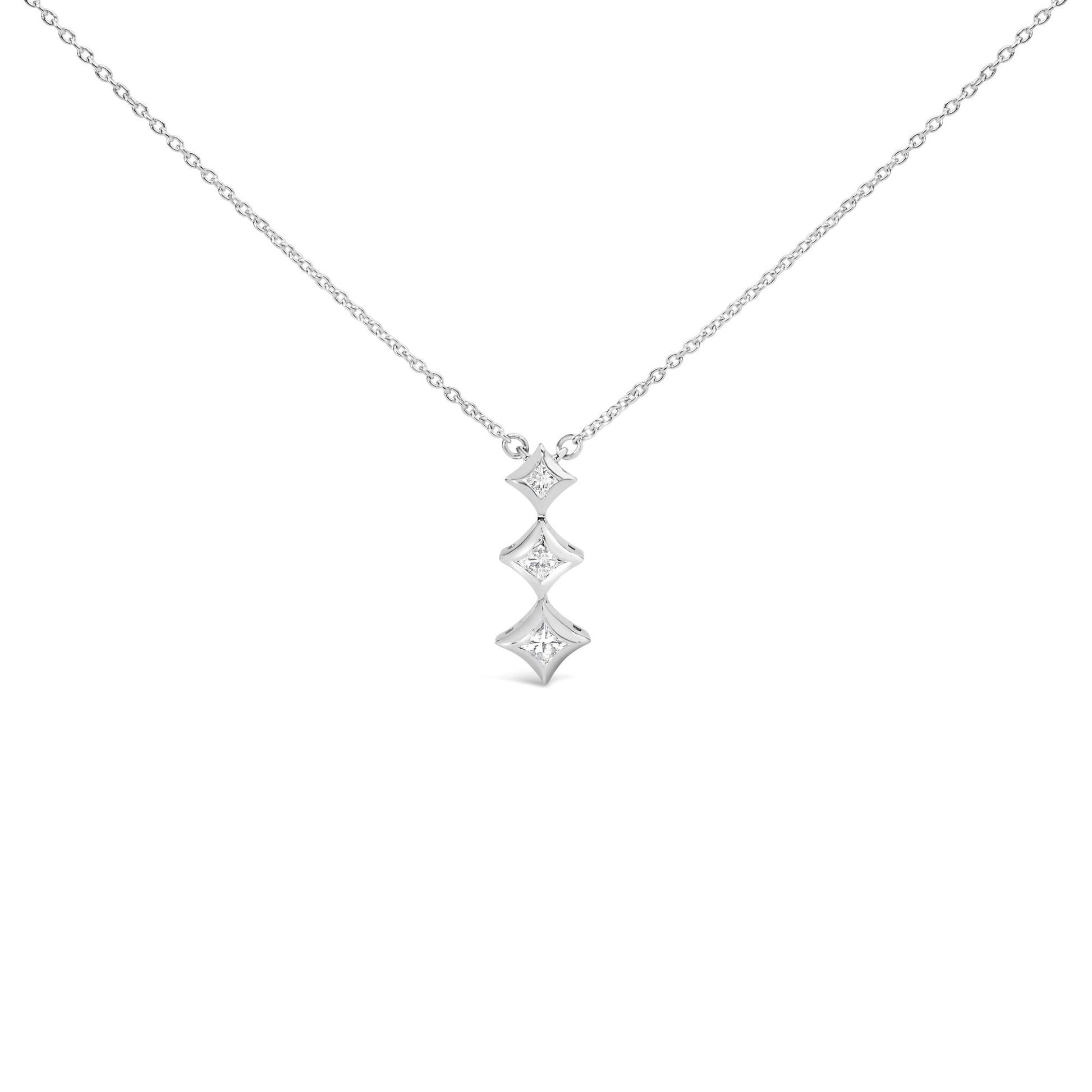 Front view of a white metal necklace with a pendant featuring three vertically aligned bezel-set white princess-shaped gemstones.