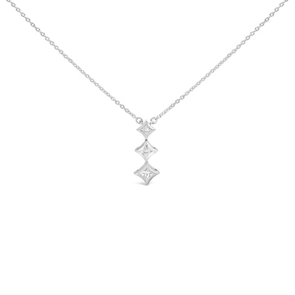 Front view of a white metal necklace with a pendant featuring three vertically aligned bezel-set white princess-shaped gemstones.