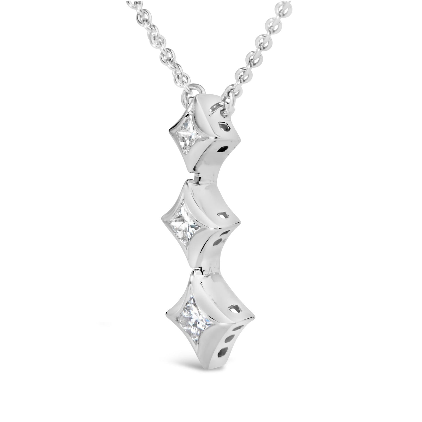 Close-up front angled view of a white metal necklace with three vertically aligned princess-shaped bezel-set white gemstones.