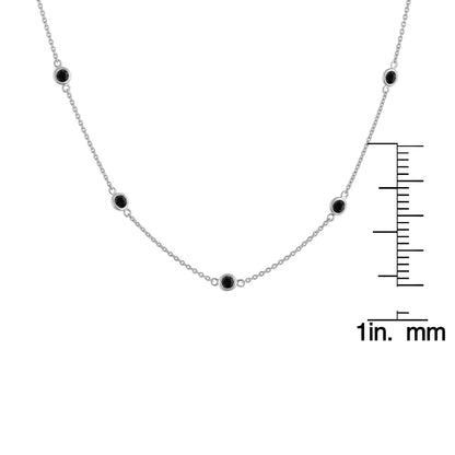 Front view of white metal necklace with round black gemstones in bezel settings, displayed on a ruler for size reference.