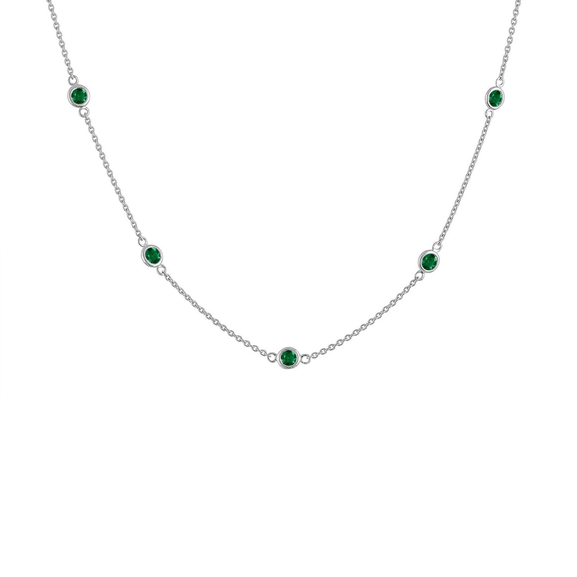 White metal necklace with evenly spaced round green gemstones in bezel settings, shown in a front-facing close-up angle.
