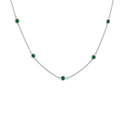 White metal necklace with evenly spaced round green gemstones in bezel settings, shown in a front-facing close-up angle.