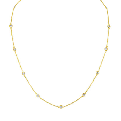 Front-facing close-up of a yellow necklace with round white gemstones in bezel settings spaced along the chain.