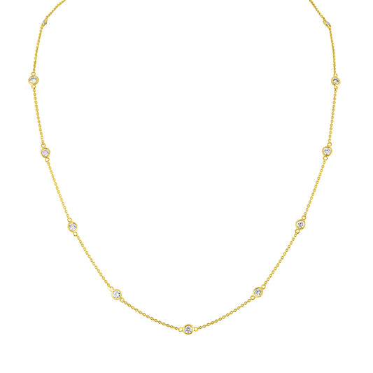 Front-facing close-up of a yellow necklace with round white gemstones in bezel settings spaced along the chain.