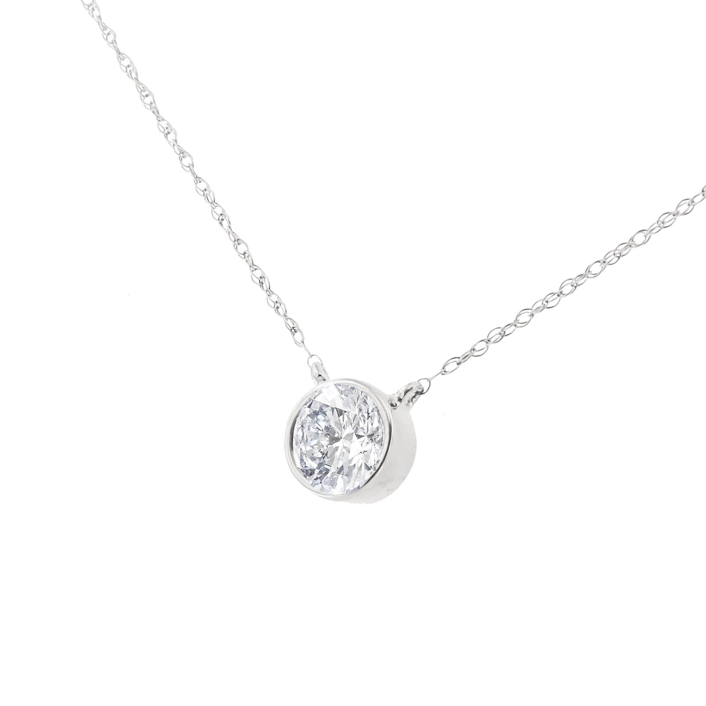 Close-up front angle of a white metal necklace with a single round white gemstone in a bezel setting.