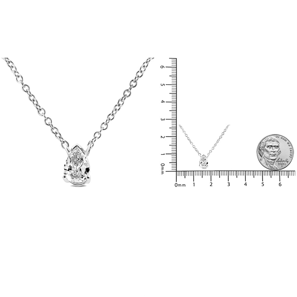 White metal necklace with a pear-shaped white gemstone in a 4-prong setting, shown in a close-up and on a ruler for size reference, viewed from the front.