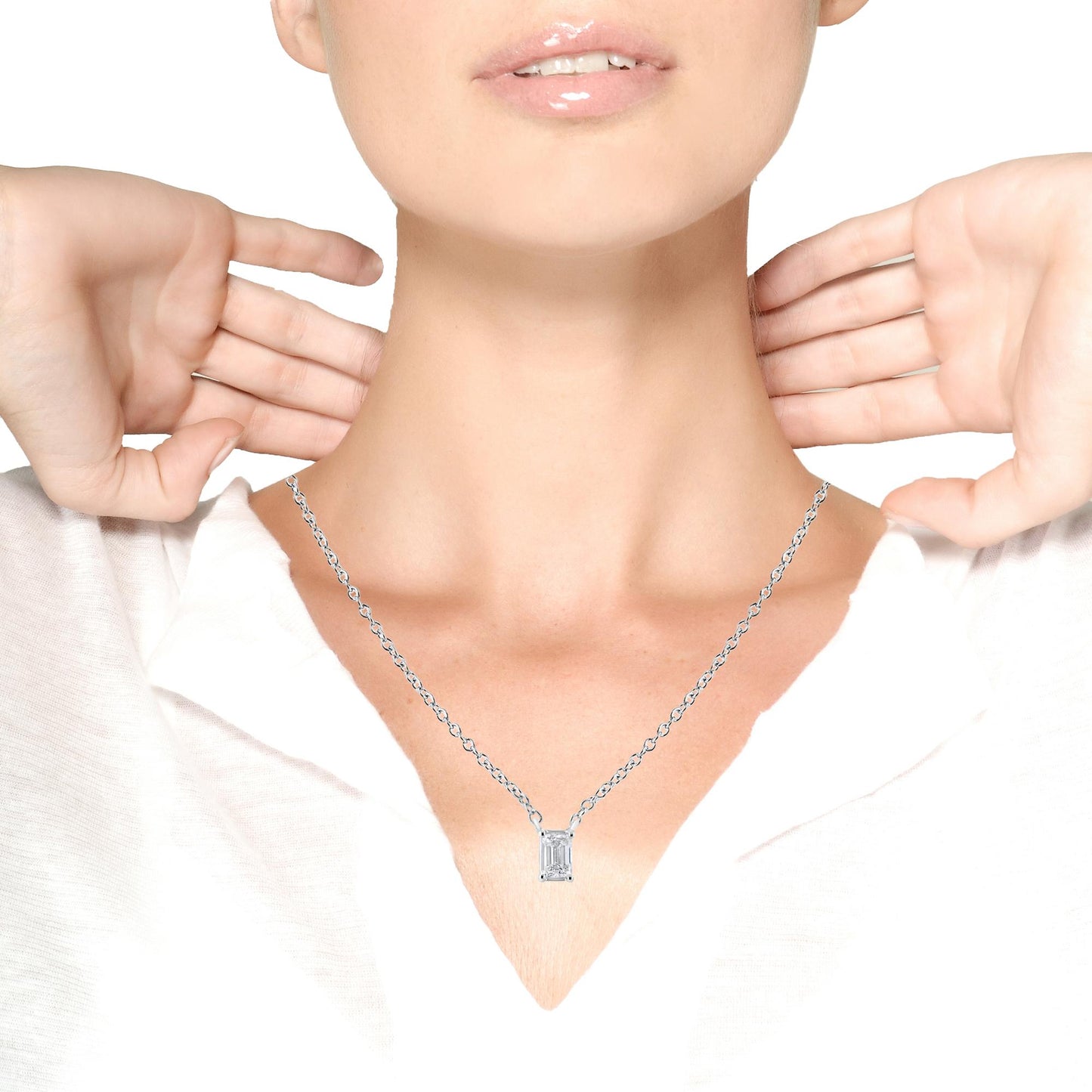 White metal necklace with a rectangular emerald-shaped white gemstone in a four-prong setting, shown on a model from the front angle.