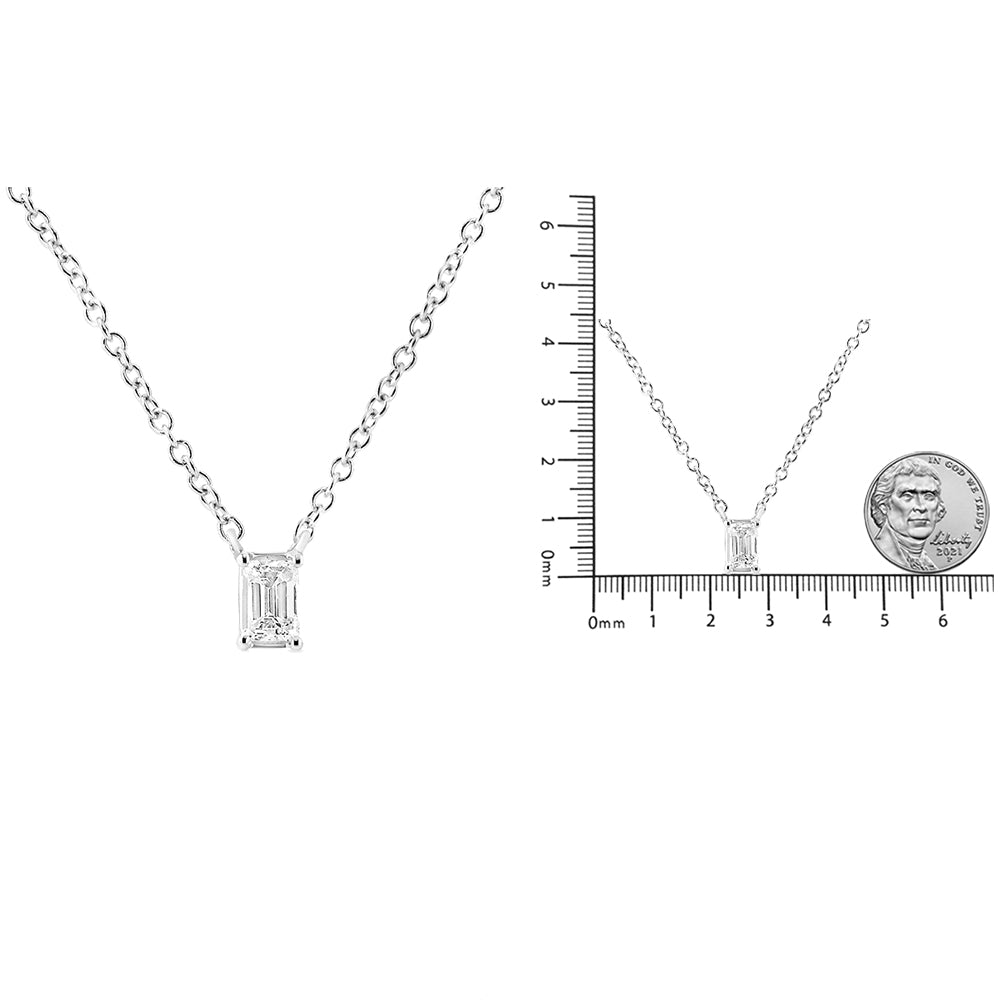Front view of a white metal necklace with a single emerald-shaped white gemstone in a 4-prong setting; second image shows the necklace laid flat next to a ruler and coin for size reference.
