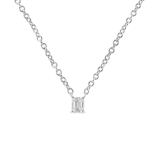 Front-facing shot of a white metal necklace with a single emerald-shaped white gemstone pendant in a 4-prong setting.