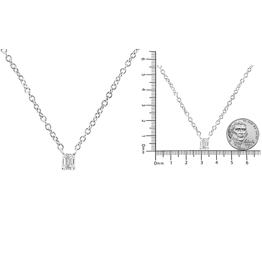 Two images of a white metal necklace with a single emerald-shaped white gemstone in a four-prong setting; one close-up front view and one front view on a ruler and next to a coin for size reference.