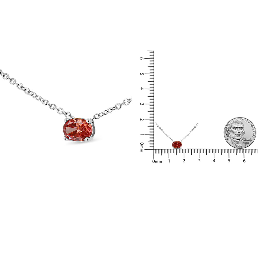 White necklace with an oval pink gemstone in a 4-prong setting, shown in a close-up angled view and placed on a ruler for size reference.