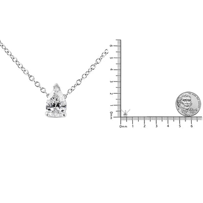 Front view of a white metal necklace with a single pear-shaped white gemstone in a prong setting, displayed next to a ruler and coin for size reference.