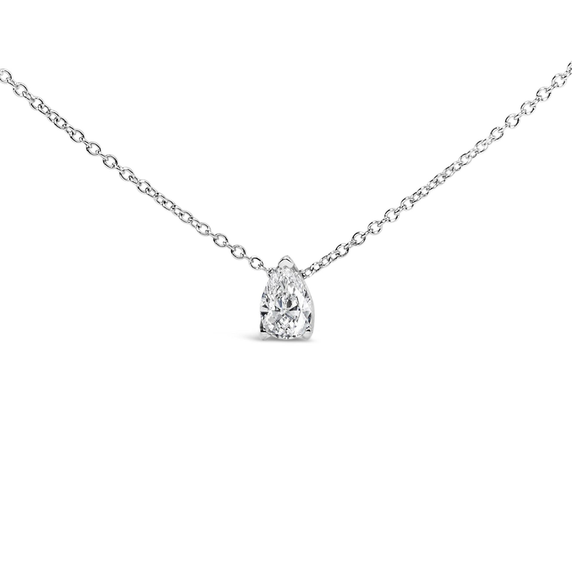 Close-up front view of a white metal necklace with a single pear-shaped white gemstone set in a 3-prong setting.
