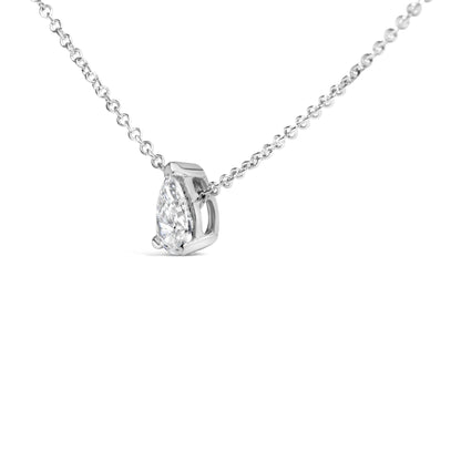 Close-up side angle of a white metal necklace with a pear-shaped white gemstone in a 3-prong setting.