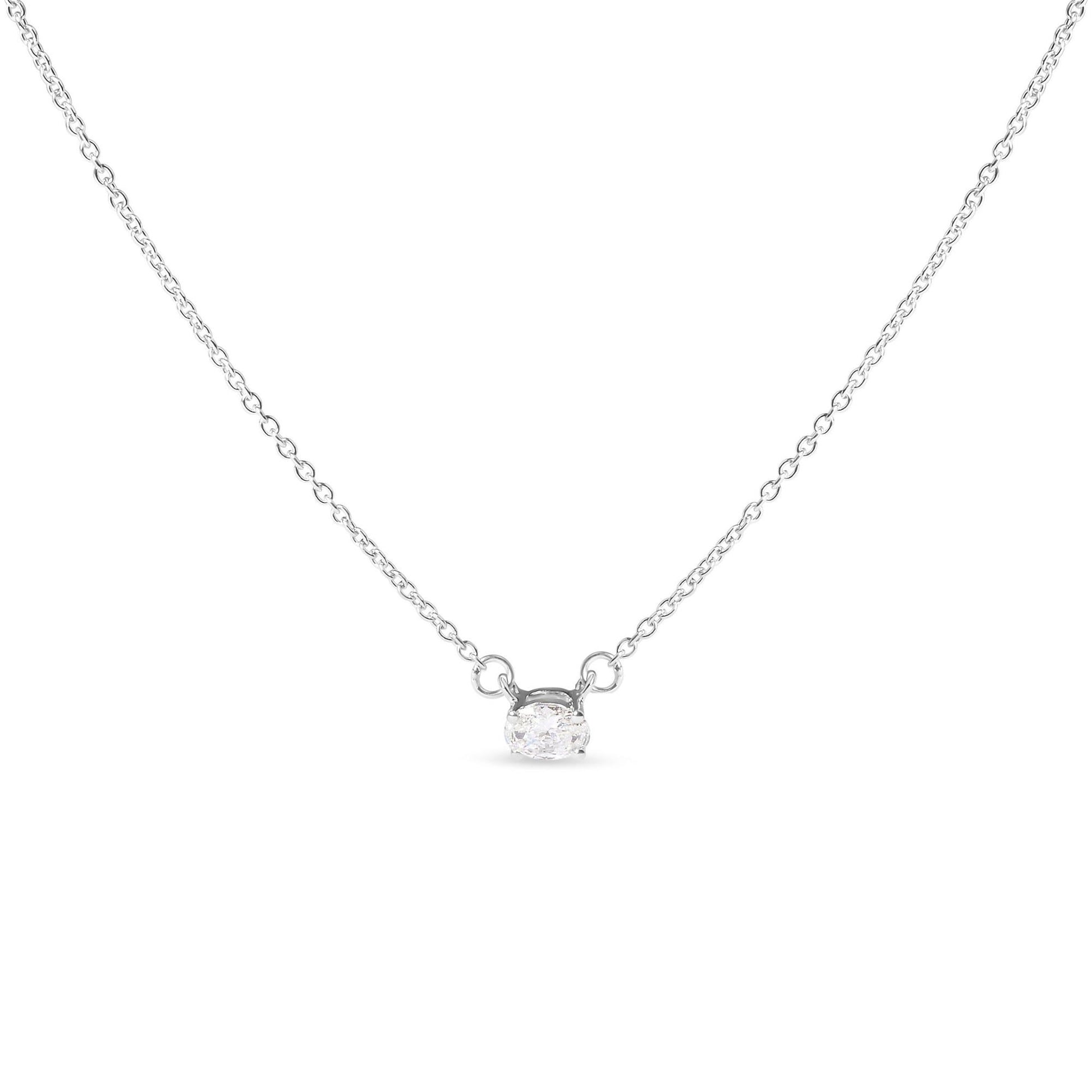Front-facing shot of a white metal necklace featuring a single oval-shaped white gemstone in a four-prong setting.
